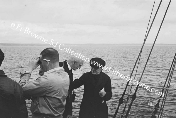 PASSENGERS ON FERRY LOOKING AT COAST